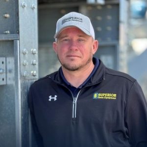 Jason Etchison standing by Superior grain dryer